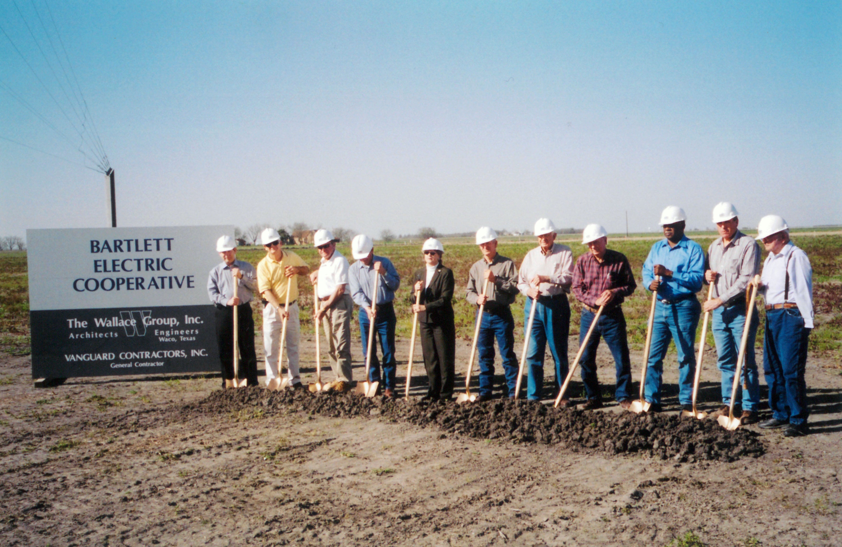 Group of Bartlett Electric Cooperative representatives holding ceremonial shovels at 2005 groundbreaking event for new office and service center
